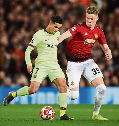  ?? — AFP ?? Out of my way: Barcelona midfielder Philippe Coutinho (left) vying for the ball with Manchester United midfielder Scott McTominay during the Champions League quarter-finals, first-leg match at Old Trafford on Wednesday.