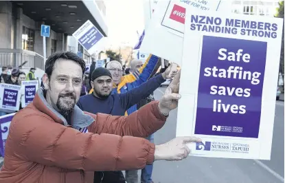  ?? PHOTO: GERARD O’BRIEN ?? Not enough, had enough . . . Dunedin nurse Craig Christense­n makes his point during the nurses’ strike earlier this month.