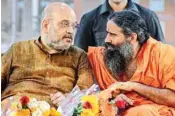  ??  ?? BJP President Amit Shah speaks with yoga guru Baba Ramdev during the inaugurati­on of newly-built second campus of Acharyakul­um at Patanjali Yog Peeth, in Haridwar, Thursday