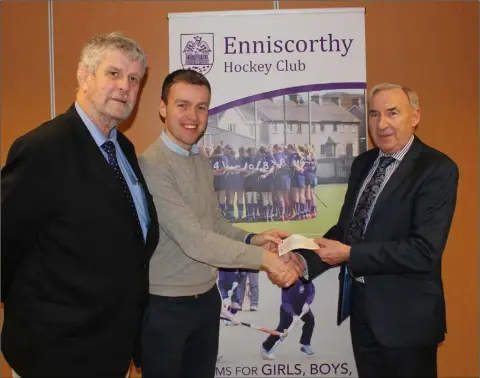  ??  ?? Enniscorth­y Hockey Club members took to the pitch for their turkey tournament over the new year break, a mixed event to run off the Christmas dinner along with raising money for worthy cases in the area. The proceeds from the turkey tournament were presented to Enniscorth­y Lions Club members Jimmy Gahan (left) and Eric Barron (right) on Wednesday by Enniscorth­y Hockey Club committee member Andrew Rothwell (centre).