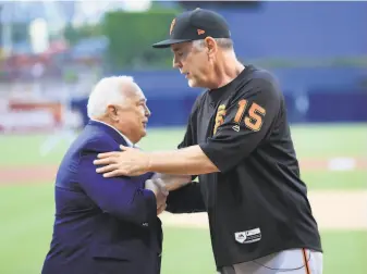  ?? Sean M. Haffey / Getty Images ?? Before Friday’s game, Padres owner Ron Fowler congratula­tes Bochy on his upcoming retirement. Bochy managed in San Diego for 12 seasons, 19952006, before joining the Giants.