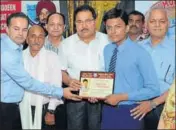  ?? HT PHOTO ?? School education minister OP Soni (centre) felicitati­ng Raghav Gupta, fifth in Punjab and first in the district in PSEB Class 10, at Jagat Jyoti School in Amritsar on Saturday.