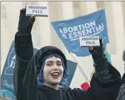  ?? PROTESTERS Jose Luis Magana Associated Press ?? wave supposed abortion pills along with signs outside the Supreme Court in December.