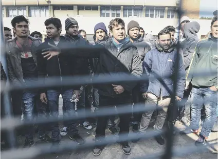  ?? Pictures: Jacques Nelles ?? HEAR US. Foreign nationals, predominan­tly from India, speak through a fence at the Desmond Tutu Refugee Centre in Pretoria. They claimed they had to pay bribes just to gain entry into the centre.