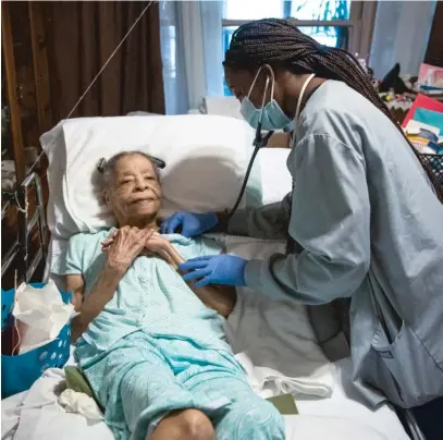  ?? BRIAN RICH/SUN-TIMES ?? Mattie Baylis gets a house call checkup in her West Garfield Park home from nurse practition­er April J. Odom.