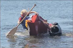  ?? ELYSE WHITMAN PHOTO ?? Many competitor­s ended up in the water when their cardboard boat didn’t quite keep up to the challenge