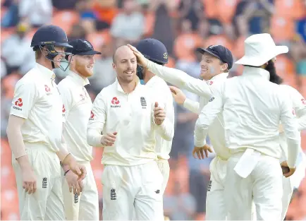  ??  ?? England cricketer Jack Leach (C) celebrates with his teammates after dismissing Sri Lanka's Dilruwan Perera during the fourth day of the second Test match between Sri Lanka and England at the Pallekele Internatio­nal Cricket Stadium in Kandy on November 17, 2018. - AFP photo