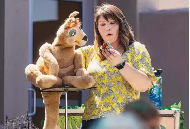  ?? CHANCEY BUSH/JOURNAL ?? Denver-based ventriloqu­ist Meghan Casey contemplat­es a Rubik’s Cube with Cassie the kangaroo at Lomas Tramway Library as part of the Albuquerqu­e/Bernalillo County summer reading program.