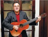  ?? PHOTO BY DONN JONES/INVISION/AP ?? Vince Gill plays the guitar at his home in Nashville. Gill doesn’t hold back on weighty topics of regret, faith, his marriage and sexual abuse on his new record “Okie” coming out Friday.