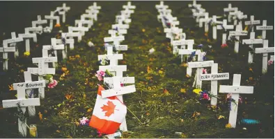  ?? NATHAN DENETTE / THE CANADIAN PRESS FILES ?? Crosses are displayed in memory of the elderly who died from COVID-19 at the Camilla Care Community facility in Mississaug­a, Ont. Ottawa's budget atonement amounts to a $3-billion investment to ensure
the provinces and territorie­s offer a higher standard of elderly care, Terry Glavin writes.