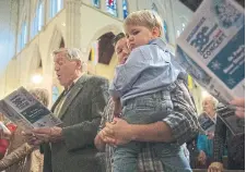  ?? RICK MADONIK TORONTO STAR FILE PHOTO ?? Honderich attends a Christmas Carol concert in 2016, part of the Star’s Santa Claus Fund, with son Robin Honderich, who is holding 21-month-old son Sebastian.