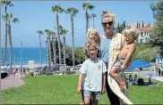  ?? ASHLEY LANDIS / AP ?? Hillary Salway poses for a photo with her children — Dane Salway, 5, Mick Salway, 1, and Beaux Salway, 3 — on Monday in San Clemente, Calif. Salway plans to send her children back to school in the fall.