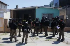  ?? Photograph: Jorge Dueñes/Reuters ?? Mexico security forces outside a house where a drug traffickin­g tunnel was discovered in 2022 that goes under the US-Mexico border between Tijuana, Mexico, and the San Diego area.