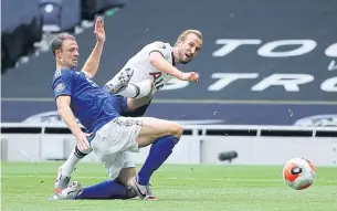  ??  ?? Tottenham’s Harry Kane, right, scores against Leicester during their Premier League match on Sunday.