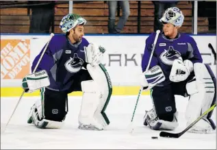  ?? DANNY MOLOSHOK/ REUTERS ?? Vancouver Canucks goalies Roberto Luongo ( left) and Cory Schneider will compete for the top job if both are back with the team next season, GM Mike Gillis said Friday. ‘ Whoever wins it will win it.’