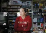  ?? THE ASSOCIATED PRESS ?? Crystal Schilleci, 32, of Altoona, Ala., stands behind a grocery store counter in Mountain Top, Ala., on Friday, Nov. 10, 2017. Schilleci says, she thinks Roy Moore is a “wonderful person, he’s been an outstandin­g member of our community for years, and...