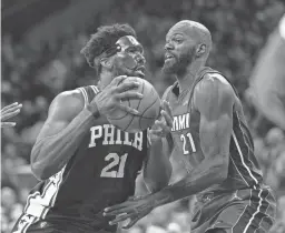  ?? BILL STREICHER/USA TODAY SPORTS ?? Philadelph­ia 76ers center Joel Embiid drives against Heat center Dewayne Dedmon on Friday in Philadelph­ia.