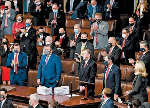  ?? WIN MCNAMEE/GETTY ?? Rep. Paul Gosar, R-Ariz., third from right, and Sen. Ted Cruz, R-Texas, second from left, are applauded by Republican Congress members on Jan. 6.