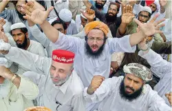  ?? — AFP ?? Activists of Pakistan opposition parties shout slogans at the provincial election commission office against the alleged election rigging in Karachi.