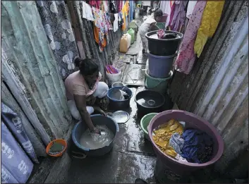  ?? RAJANISH KAKADE — THE ASSOCIATED PRESS ?? A woman washes utensils outside her house in a slum area on the eve of World Water Day in Mumbai, India, on Tuesday.
