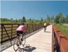  ?? BOULDER JUNCTION CHAMBER OF COMMERCE ?? Cyclists ride over a bridge on the Heart of Vilas trail system in Vilas County.