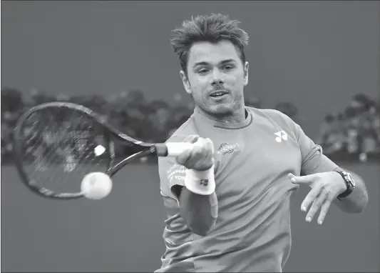  ?? Photo: IC ?? Stan Wawrinka of Switzerlan­d hits a forehand return to Germany’s Philipp Kohlschrei­ber in their third- round match at the ATP Indian Wells Masters on Monday.