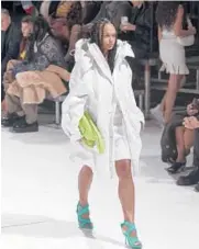  ?? ELAINE CROMIE/THE NEW YORK TIMES ?? A model walks in the Bottega Veneta spring 2022 fashion show Oct. 21 in Detroit. Veneta’s latest show was rich in Detroit techno.