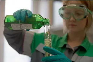  ?? — Bloomberg ?? An employee checks the quality of a fuel sample in a laboratory at a fuel storage facility in Russia. Officials are stressing the nation’s ability to keep increasing record output.