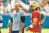  ?? Matt Ludtke Associated Press ?? JETS COACH Robert Saleh laughs with Packers quarterbac­k Aaron Rodgers during a 2021 encounter.