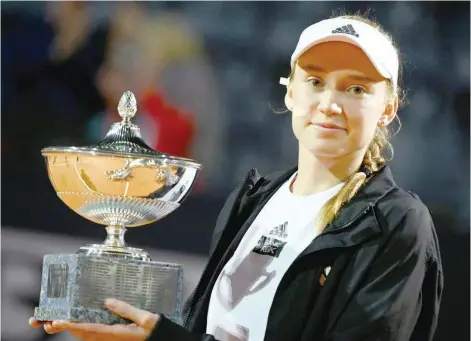 ?? — AFP ?? Kazakhstan’s Elena Rybakina with the trophy after the WTA Rome Open final against Ukraine’s Anhelina Kalinina, who forefeited due to an injury, at Foro Italico.