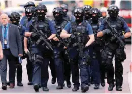  ??  ?? Armed police officers walk outside Borough Market yesterday.