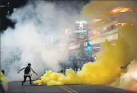  ?? REUTERS ?? Police lob tear gas to disperse demonstrat­ors after a Trump rally in Phoenix on Tuesday.