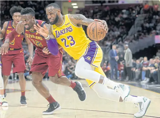  ??  ?? The Lakers’ LeBron James, right, drives against the Cavaliers’ David Nwaba at Quicken Loans Arena in Cleveland on Wednesday.