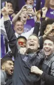  ?? AP PHOTO ?? GOING WILD-CATS: Coach Chris Collins and Northweste­rn celebrate the first NCAA tournament invite in school history.