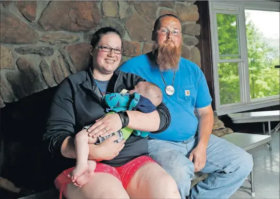  ?? [BROOKE LAVALLEY/DISPATCH PHOTOS] ?? Krista Parker and husband Noah — with 5-month-old son Sam — have an extended history with Camp Hamwi.