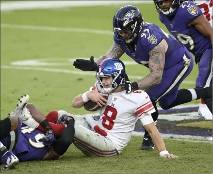  ?? NICK WASS - THE ASSOCIATED PRESS ?? New York Giants quarterbac­k Daniel Jones (8) is sacked by Baltimore Ravens linebacker Chris Board, let, as defensive end Derek Wolfe (95) helps bring him down during the second half of an NFL football game, Sunday, Dec. 27, 2020, in Baltimore. The Ravens won 27-13.