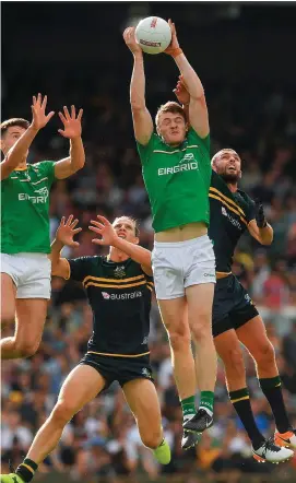  ??  ?? Kevin Feely fields the ball ahead of Ireland team-mate Niall Grimley and Australia’s Nat Fyfe and Rory Laird during the Internatio­nal Rules series