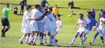  ?? ADOLPHE PIERRE-LOUIS/JOURNAL ?? Los Lunas players rush to embrace each other and celebrate their upset of top-ranked St. Pius. The No. 9-seeded Tigers advance to today’s Class 4A boys semifinal round against No. 5 Los Alamos.