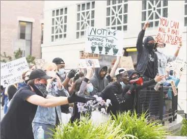  ?? Tyler Sizemore / Hearst Connecticu­t Media ?? Protesters shout and hold signs during the Black Lives Matter protest in front of the Public Safety Complex in Greenwich on Monday. More than 50 protesters gathered peacefully in honor of George Floyd and all other victims of police brutality.