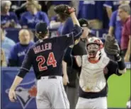  ?? CHARLIE RIEDEL — THE ASSOCIATED PRESS ?? Cleveland Indians’ reliever Andrew Miller (24) and catcher Roberto Perez celebrate their team’s win against the Toronto Blue Jays in Game 3 of the ALCS last October. Manager Terry Francona used Miller in all sorts of situations last season, an approach...