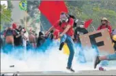  ?? AFP ?? Demonstrat­ors clash with police during a protest against the labour and social security reforms of Brazilian President Michel Temer. On Thursday, his government withdrew a decree that had deployed army soldiers in the capital Brasilia.