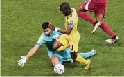  ?? ASSOCIATED PRESS ?? Ecuador’s Enner Valencia (center) is fouled by Qatar’s goalkeeper Saad Al Sheeb during the World Cup match between Qatar and Ecuador at the Al Bayt Stadium in Al Khor, Qatar, Sunday. Valencia scored the first goal of the tournament on the ensuing penalty kick.