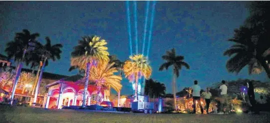  ?? JENNIFER LETT/SUN SENTINEL PHOTOS ?? Spotlights illuminate the night sky at Broken Sound Club in Boca Raton as a salute to medical workers, first responders and others involved in the fight against the coronaviru­s.