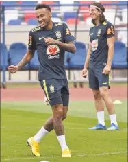  ?? Ekaterina Lyzlova / Associated Press ?? Brazil’s Neymar, left, smiles during a training session in Sochi, Russia on Wednesday. Brazil will face Belgium in the quarterfin­als of the World Cup.