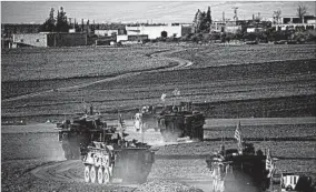  ?? DELIL SOULEIMAN/GETTY-AFP ?? A convoy of U.S. armored vehicles rolls last month on the outskirts of the northern Syrian city of Manbij. The military is keeping Syrian and Iraqi deployment­s quiet.