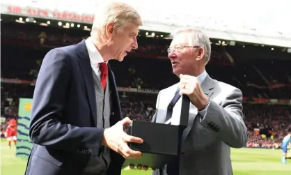  ??  ?? Former Manchester United manager Sir Alex Ferguson presented Arsène Wenger with a gift to mark his Arsenal retirement. Photograph: Stuart MacFarlane/Arsenal FC via Getty Images