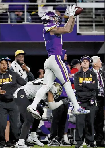  ?? AP/JEFF ROBERSON ?? ABOVE: Minnesota Vikings wide receiver Stefon Diggs makes a catch over New Orleans Saints free safety Marcus Williams on his way to the winning touchdown with no time left Sunday. The Vikings defeated the Saints 29-24 to advance to the NFC Championsh­ip...