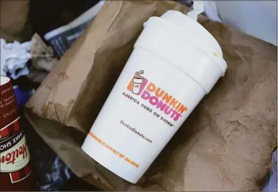  ?? Mark Lennihan / Associated Press ?? A foam coffee cup sits in a trash bin in 2018. Dunkin’ switched from foam to paper cups in 2020, and now the Connecticu­t Senate has voted in favor of a moratorium on polystyren­e foam containers.