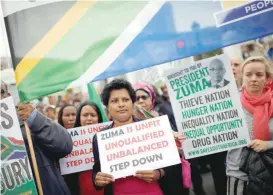  ?? — Reuters ?? Demonstrat­ors protest against South African President Jacob Zuma’s firing of Finance Minister Pravin Gordhan, outside Parliament in Cape Town, South Africa on Friday.