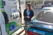  ?? STAFF FILE PHOTO ?? Dade County resident BriAnna Lunsford pumps gas into her car at a Mapco Mart in Rising Fawn, Ga.